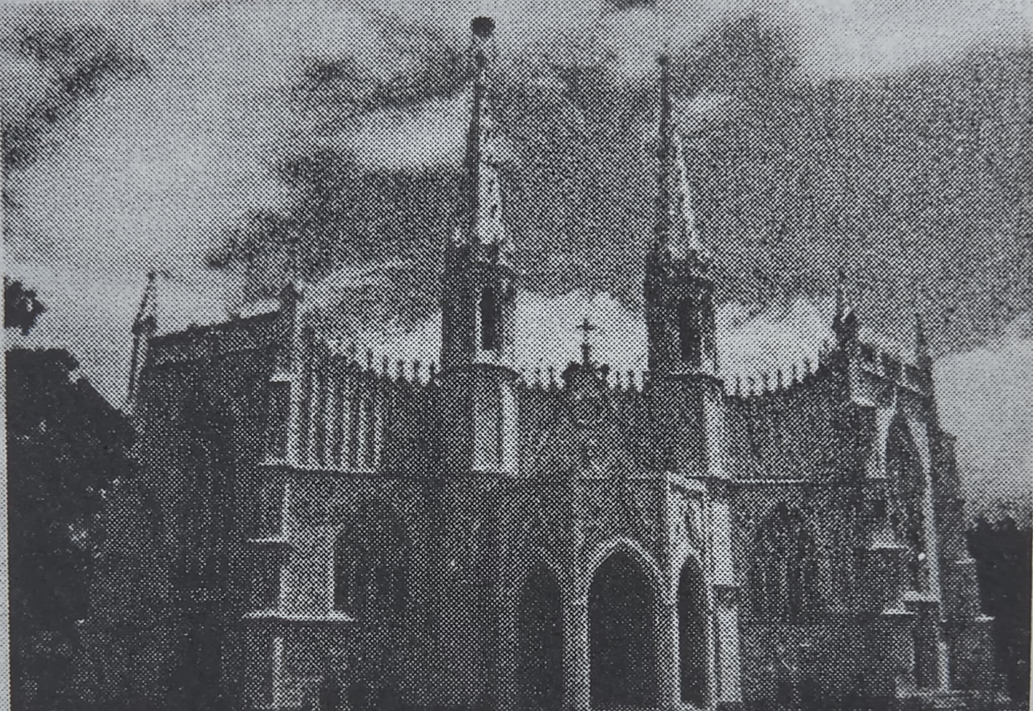 An archival black-and-white photograph of the great two-nave church at Vadakkankulam, its spires and pinnacles against a clouded sky